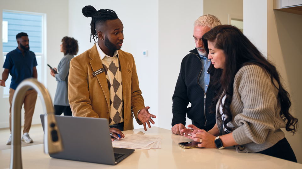 Real-estate salesperson talking with home buyers