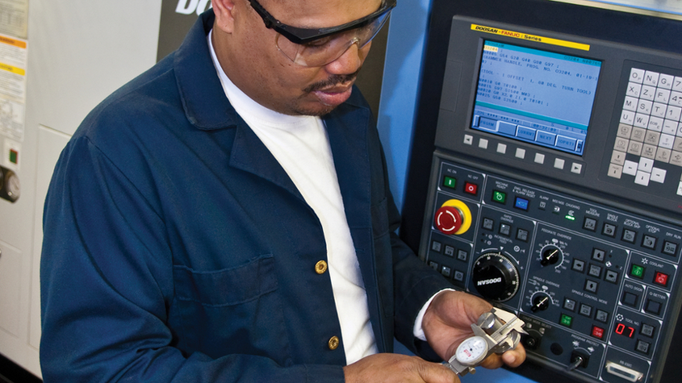 man using computerized manufacturing machine